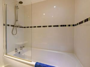 a bathroom with a shower and a bath tub with a glass door at 1 Bed in Doncaster oc-93571 in Mattersey +12 photos