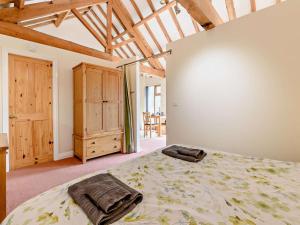 a bedroom with a large bed and a wooden cabinet at 1 Bed in Doncaster oc-93571 in Mattersey