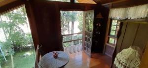 a room with a table and a large window at Casa de Campo em Monte Verde in Camanducaia +13 photos