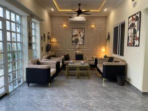 a living room with couches and a table at ASNB Farm House 2BHK with Pool in Multan