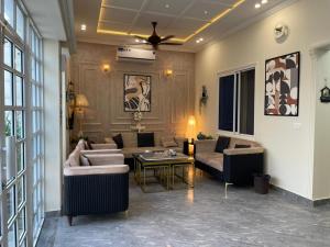 a living room with a couch and a table at ASNB Farm House 2BHK with Pool in Multan +6 photos