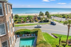 an apartment with a swimming pool and a view of the beach at Oceanfront 3BR with Stunning Views, Private Balcony and Pool in Myrtle Beach