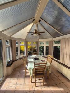 a dining room with a table and chairs and windows at Rome avenue in Abingdon