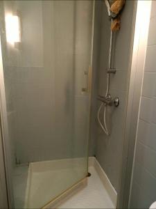 a shower with a glass door in a bathroom at FamousHouse in Le Havre