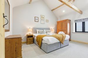 a bedroom with a large bed and a window at The Saddlery in Norwich