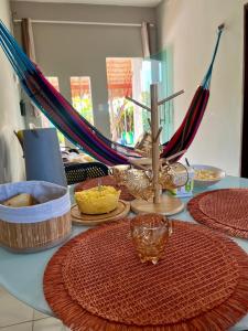a table with plates and umbrellas on it at Varanda das Dunas in Santo Amaro