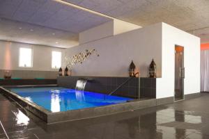 a swimming pool in a building with a water fountain at Historic Gem - Lift - Balcony in Basel