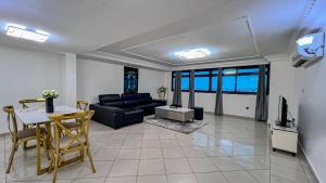 a living room with a couch and a table at Residence Blue Sky in Douala