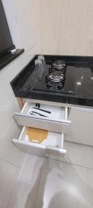 a stove in a kitchen with a counter top at Residencial Hanna in Anápolis +207 photos