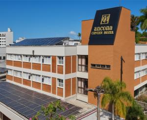a hotel with solar panels on the roof at Ancona Center Hotel in Amparo