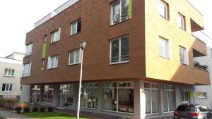 a large brick building with white windows at Modern city center apartment with private parking in Martin