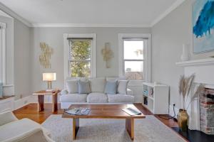 a living room with a white couch and a coffee table at Savannah Suite on Front in Wilmington