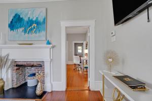 a living room with a fireplace and a table at Savannah Suite on Front in Wilmington +46 photos