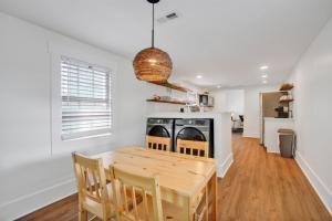 a kitchen with a wooden table and chairs in a room at Urban Oasis in Wilmington