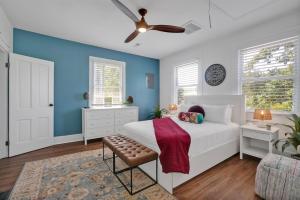 a bedroom with a white bed and blue walls at Urban Oasis in Wilmington