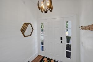 a hallway with a white door and a mirror at Urban Oasis in Wilmington +18 photos