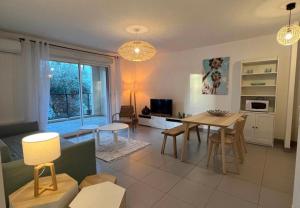 a kitchen and living room with a table and chairs at RIVIERA COTTAGE in Mandelieu-La Napoule +20 photos