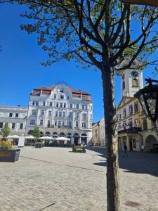 a large white building with a clock tower on a street at Apartament Azul in Cieszyn