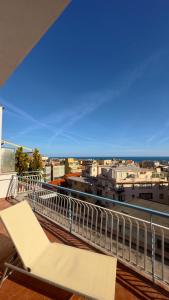 a white bench on a balcony with a view of the city at NB Luxury Attico Vista Mare in Sanremo
