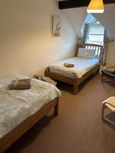 a bedroom with two beds and a window at Trotters Place - Bradwell in Bradwell