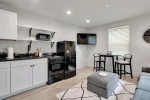 a kitchen and living room with a couch and a table at The Pearl Stylish Couples Getaway in Wilmington