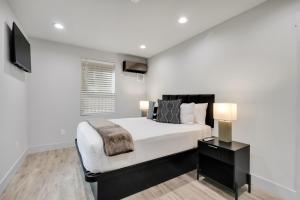 a bedroom with a large bed and a television at The Pearl Stylish Couples Getaway in Wilmington +13 photos