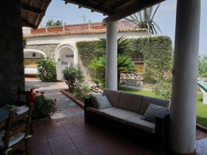 a couch on a patio in front of a house at Villa Brigio in Forio d'Ischia