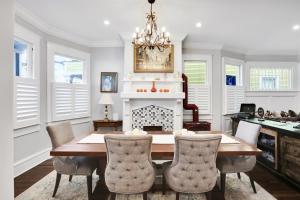 a dining room with a table and a fireplace at The Simmons House on 5th Ave in Wilmington