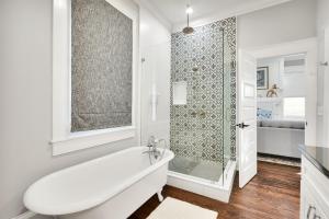 a white bathroom with a tub and a shower at The Simmons House on 5th Ave in Wilmington +41 photos