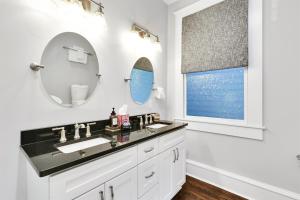 a bathroom with a sink and a mirror at The Simmons House on 5th Ave in Wilmington