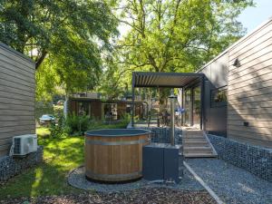 a backyard with a hot tub and a house at Resort Walsdorf in Tandel +26 photos