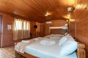 a bedroom with a large bed in a wooden room at Hotel Bicaj in Shkodër