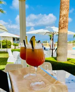 two wine glasses sitting on a table at a resort at Grand Hotel Stella Maris Italia in Palmi