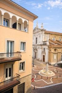 a building with a fountain in the middle of a street at Casa di Cocco in Alzano Lombardo