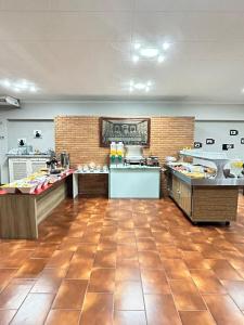 a restaurant with a buffet line with food at Ancona Center Hotel in Amparo