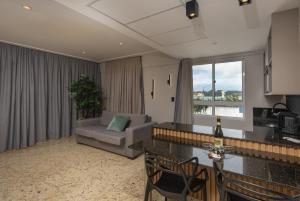 a living room with a couch and a table at Coral Plaza Apart Hotel in Natal