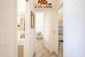 a hallway with white walls and a room with a door at Costa Corallina Villa with direct beach access and stunning views in Costa Corallina +77 photos