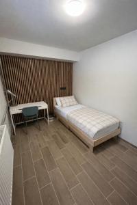 a bedroom with a bed and a table and a desk at Private Room in the Heart of Tallinn in Tallinn