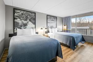 a hotel room with two beds and a window at Super 8 by Wyndham Kingsport /I-81 in Kingsport