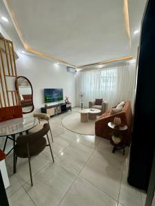 a living room with a couch and a table at Nahé Résidence Deux Plateaux in Abidjan