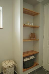 a closet with wooden shelves and a basket at Maison individuelle in Triac-Lautrait +1 photo