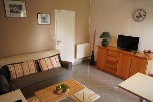a living room with a couch and a table at Maison individuelle in Triac-Lautrait