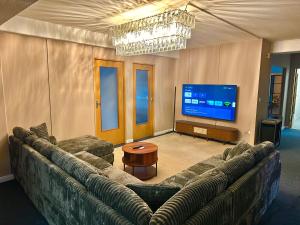 a living room with a large couch and a flat screen tv at City Apartment Hamburg Work Relax Repeat in Hamburg +11 photos