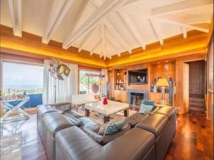 a living room with a leather couch and a table at Villa Carla in Bonifacio