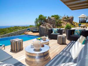 a patio with furniture and a swimming pool at Villa Carla in Bonifacio