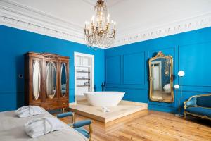 a blue room with a sink and a mirror at Água Hotels Lagos Bay in Lagos