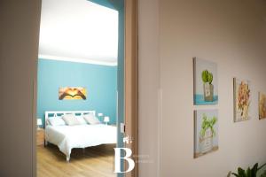 a bedroom with a bed with a blue wall at Belvedere Benedetto in Castelnuovo Parano