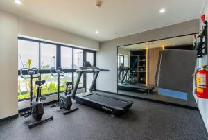 a gym with two treadmills and a treadmill and a mirror at Ejército City Lofts & Apartments by Geko in Lima