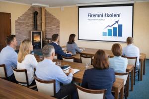 a group of people sitting around a table in a meeting at Pension Javorník in Jeřmanice