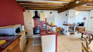 a kitchen with a counter and a stove top oven at Chez mamie couture in Bussière-Boffy